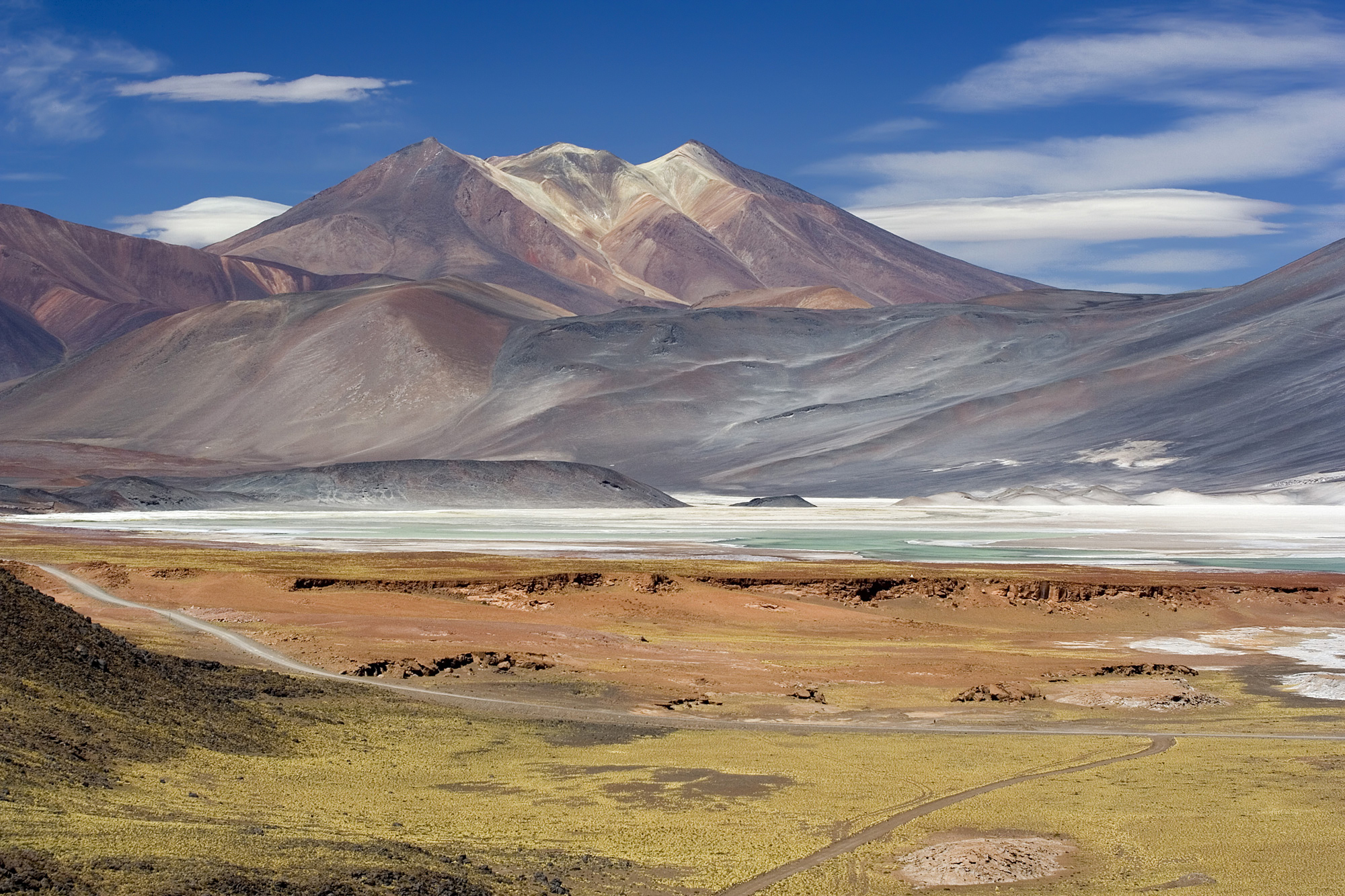 Cerros de Incahuasi are mountains with the Salar de Talarr salt flat in the foreground, located near San Pedro de Atacama, at an elevation of 4,010 meters in Chile.